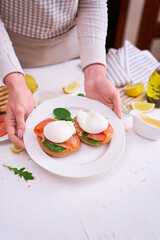 Cream cheese, Smoked salmon and poached egg toasts on a plate