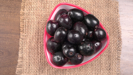 Jambul or Jamun (Syzygium cumini) isolated on wooden background