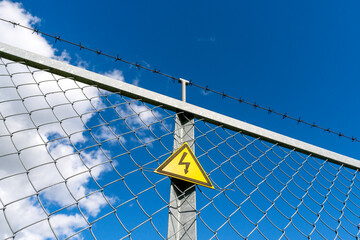 Fototapeta premium Warning sign danger on the fence