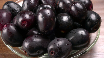 Jambul or Jamun (Syzygium cumini) isolated on wooden background