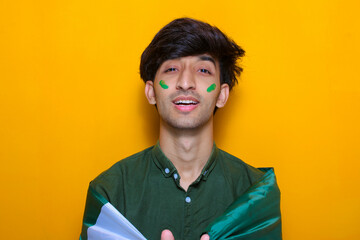 Pakistani, Indian, South Asian young boy holding flag celebrating or cheering Pakistan cricket team, Cricket fan concept