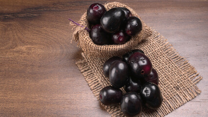 Jambul or Jamun (Syzygium cumini) isolated on wooden background