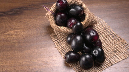 Jambul or Jamun (Syzygium cumini) isolated on wooden background