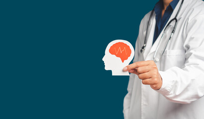 Doctor in uniform holding a white head with a red brain symbol while standing on a blue background
