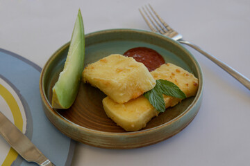 Matured cheese served with melon slice	