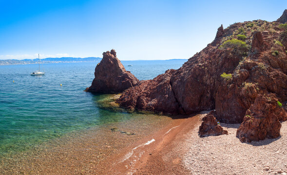 Sailboat on the Mediterranean sea and Aiguille beach in Th&eacute;oule sur Mer on the French Riviera
