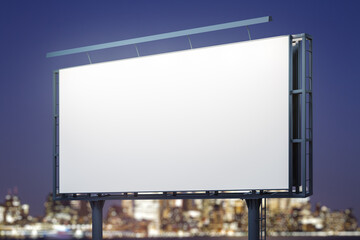 Fototapeta premium Blank white horizontal billboard on city buildings background at night, perspective view. Mockup, advertising concept