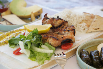 Chicken leg fillet served with green salad, aromatic rice, lemon slices and made in house mustard.	