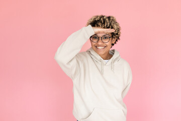 Smiling African American woman in studio. Female model with curly hair fooling around, smiling. Portrait, emotion concept