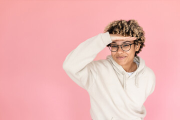 Smiley African American woman in studio. Female model with curly hair fooling around, smiling. Portrait, emotion concept