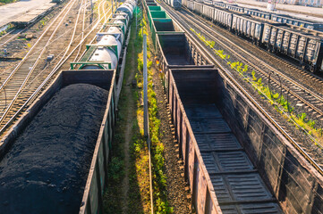 Railway wagons loaded with coal at the railway station. The wagons are on the railway tracks....