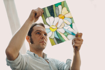 Restorer master male checking stained glass window project