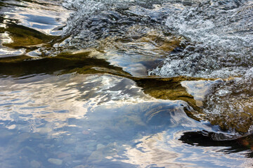 water flow of a mountain river with clear water close-up