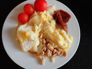 scrambled eggs with vegetables and cheese on a plate