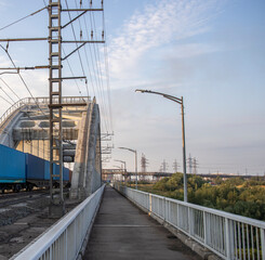 Freight train rides on the railway bridge. Industrial Zone.