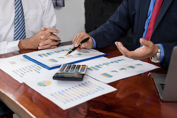 Two business leaders talk about charts, financial graphs showing results are analyzing and calculating planning strategies, business success building processes