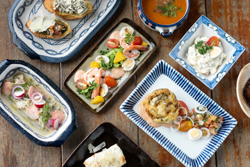 selection of many different tapas on rustic wood table