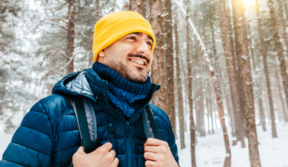 Winter hike on snow mountain young happy hiker man walking. Europe travel adventure trek in nature...
