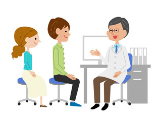 診察室で男性医師に説明を受ける若い夫婦