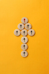 Many gray arrows follow one red arrow. The symbol of following the leader straight to the goal