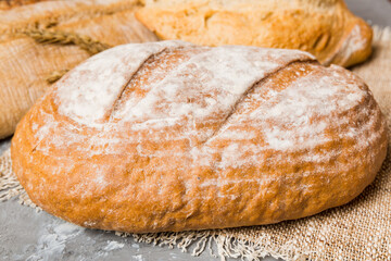 Homemade natural breads. Different kinds of fresh bread as background, perspective view with copy space