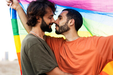 Obraz premium Happy couple with a pride flag. LGBT community.