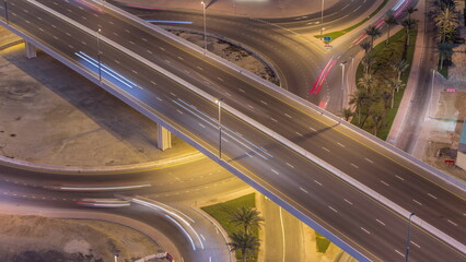 Aerial top view city traffic on elevated crossroad in Dubai Business bay night timelapse.