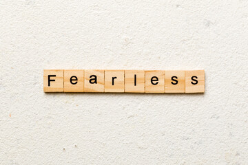 Fearless word written on wood block. Fearless text on cement table for your desing, concept