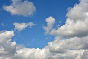 White, fluffy clouds in blue sky. Background from clouds.