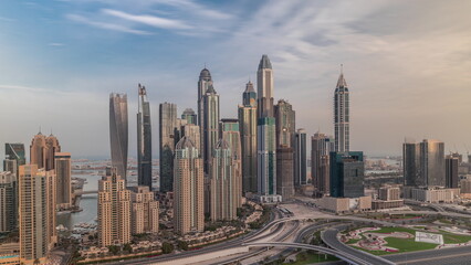 Fototapeta na wymiar Skyscrapers of Dubai Marina near Sheikh Zayed Road with highest residential buildings morning timelapse