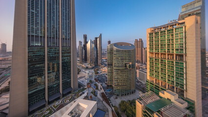 Fototapeta na wymiar Dubai international financial center skyscrapers with promenade on a gate avenue aerial all day timelapse.