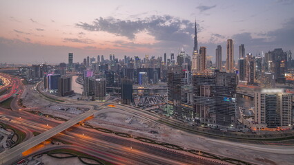Obraz na płótnie Canvas Skyline with modern architecture of Dubai business bay towers day to night timelapse. Aerial view
