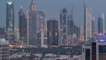 Rows of skyscrapers in financial district of Dubai aerial night to day timelapse.