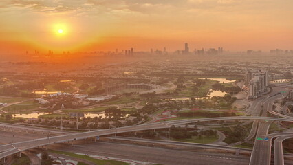 Sunrise over Golf course with green lawn and lakes, villa houses behind it timelapse.