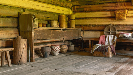 The interior of an old country house built in the 19th century in the countryside. Birch bark products, pots for cooking in a rustic wooden house.