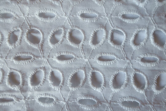 Macro of vintage white eyelet embroidery cotton fabric