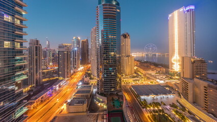 Fototapeta na wymiar Panoramic view of the Dubai Marina and JBR area and the famous Ferris Wheel aerial night to day timelapse