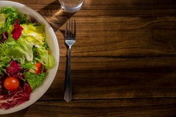 Healthy bowl of salad on wooden table