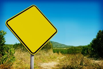 Obraz premium Yellow road sign by mountain trail