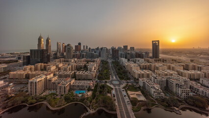 Obraz premium Panorama of skyscrapers in Barsha Heights district and low rise buildings in Greens district aerial all day timelapse.