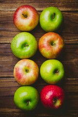 Red and green apples on table