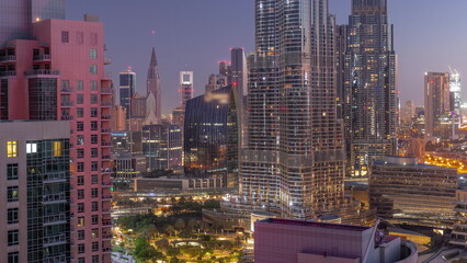 Aerial view of Dubai International Financial Centre district skyscrapers night to day timelapse