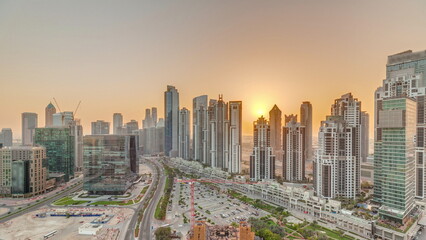 Bay Avenue during sunset with modern towers in Business Bay aerial panoramic timelapse, Dubai