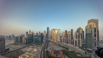 Panorama of Bay Avenue with modern towers residential development in Business Bay aerial all day timelapse