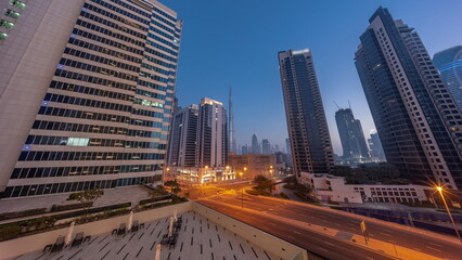 Obraz premium Aerial panoramic looking up view to Dubai downtown and difc skyscrapers night to day timelapse.