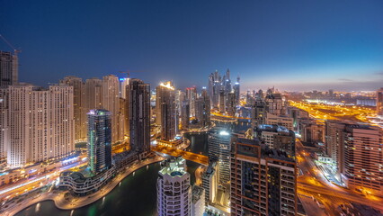 Fototapeta na wymiar Panorama of various skyscrapers in tallest recidential block in Dubai Marina aerial night to day timelapse