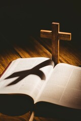 Cross with shadow falling on bible