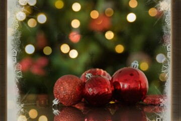 Fototapeta na wymiar Ornaments against illuminated Christmas tree