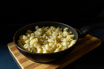 Fried pasta in a round frying pan