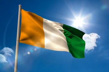 Ivory coast national flag on flagpole 